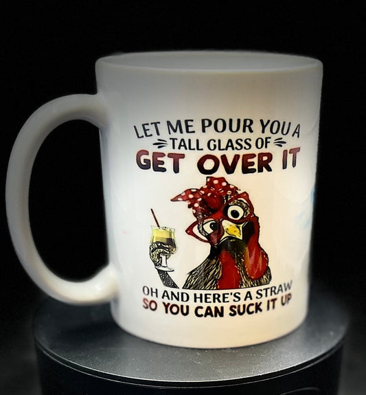 The Chicken Ceramic Mug by Kreative Kreationz features an adorable illustration of a chicken wearing a red bandana and glasses, holding a yellow drink and straw. The text humorously reads, "Let me pour you a tall glass of get over it. Oh and here's a straw so you can suck it up." It's the perfect gift for Swiftie fans!