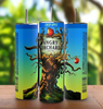 Three cans of Angry Orchard Crisp Apple Hard Cider are arranged with their labels showing. The central can features the Angry Orchard logo with an illustration of a gnarled tree with apples. The background is a blurred image of a sunny orchard, next to a Kreative Kreationz product: the Angry Orchard 20oz Tumbler boasting durable construction and 20 oz capacity.
