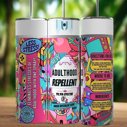 Three brightly colored spray cans labeled "Adulthood Repellant" with playful, vibrant designs, from the brand Kreative Kreationz. The front can reads "99.99% Effective" and "Eliminates Stress of Adulthood with One Spray." Side cans display directions, usage locations, and ingredient lists—just like the Adulthood Repellant Spray 20oz Tumbler that keeps beverages hot or cold.