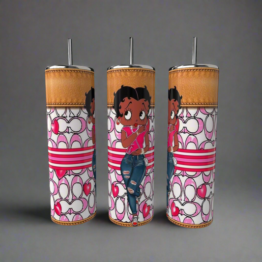 The Kreative Kreationz Betty B Coach 20oz Skinny Tumblers are adorned with Betty Boop in red tops and jeans against heart and loop patterns in red, pink, and white. Each tumbler includes a metal straw and an amber-colored lid.