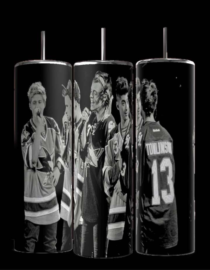 The Kreative Kreationz One Direction B&W 20oz Stainless Steel Tumbler offers a sleek black-and-white design depicting a group of people in hockey jerseys. Two individuals are holding microphones, and one proudly displays "Tomlinson 13." The front is accentuated with a spill-proof lid and reusable straw.