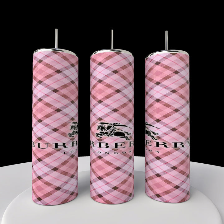 Three Kreative Kreationz Burberry 20oz Skinny Tumblers, featuring pink plaid patterns with the Burberry name and logo, are displayed against a black background on a round white platform, highlighting an elegant and seamless design.