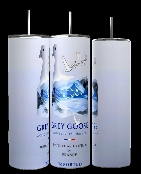 Three cylindrical bottles of Grey Goose vodka are displayed against a black background. The bottles feature a white label with an illustration of geese flying over blue and white landscapes and are marked with text indicating the vodka is distilled in France. Experience this sleek design now featured on the new, durable Grey Goose 20oz Tumbler by Kreative Kreationz.