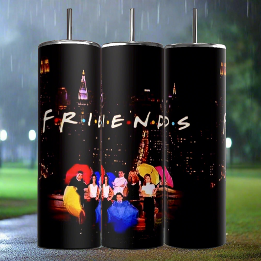 Three Kreative Kreationz Friends TV Show 20oz Tumblers feature the logo and an image from the television show "Friends." The image depicts the main characters holding colorful umbrellas against a nighttime city backdrop with streetlights and raindrops. Each Friends Sublimated Tumbler includes a reusable straw and double-wall insulation.