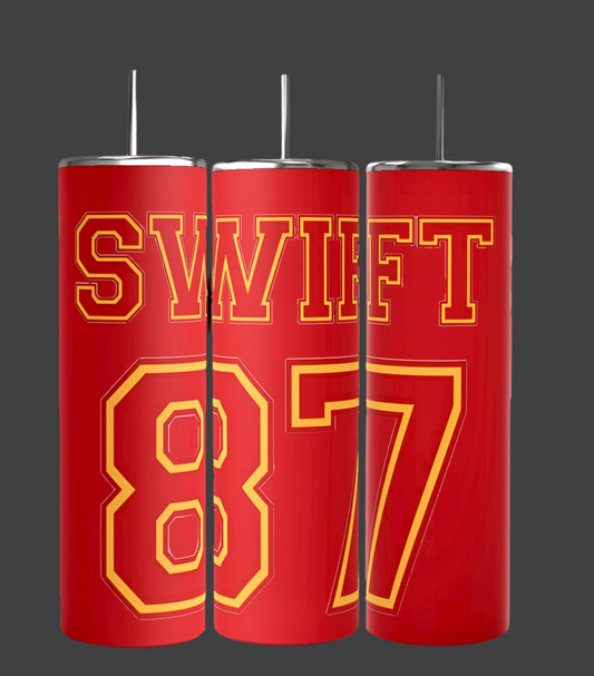 Three red 87 Chiefs tumblers with silver lids and straws from Kreative Kreationz are showcased against a gray background, featuring large yellow "SWIFT 87" text. Perfect for fans wanting a personalized Taylor Swift Chiefs tumbler experience.