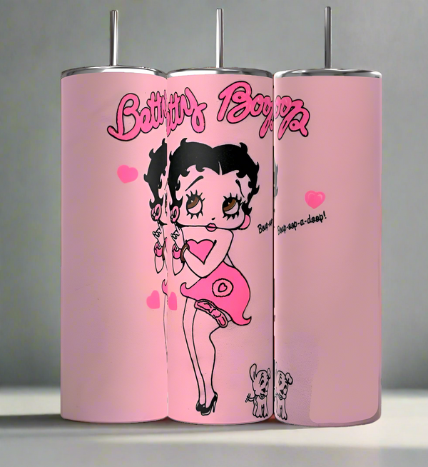 Kreative Kreationz's BB 20oz Skinny Tumbler boasts a durable sublimated design showcasing Betty Boop in a pink dress and heels, surrounded by hearts. Two small dogs add charm at her feet, with the text "Betty Boop" and "Boop-Oop-a-Doop!.