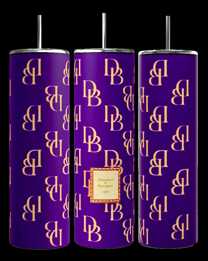 Three D&B -Purple 20oz Tumblers by Kreative Kreationz feature a vibrant purple background adorned with gold "DB" monograms. The central tumbler is highlighted by a tan label reading "Dooney & Bourke 1975." Each tumbler comes equipped with a metal straw and offers double-wall insulation to ensure optimal temperature retention.