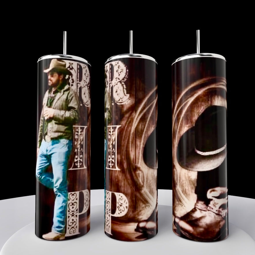 Three Yellowstone RIP 20oz stainless steel tumblers by Kreative Kreationz are displayed on a white surface against a black background. They feature cowboy-themed designs with western-style lettering, including imagery of a man in a cowboy hat and boots. Each comes with a spill-proof lid.