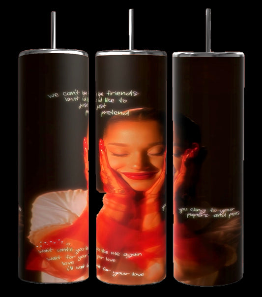 Three "External Sunshine | Ariana Grande 20oz Tumblers" by Kreative Kreationz, each featuring a close-up image of a serene woman with her hands on her cheeks. The background showcases handwritten text in white, creating a warm, intimate atmosphere. The vibrant photographic design is complemented by the spill-proof lid for convenience.