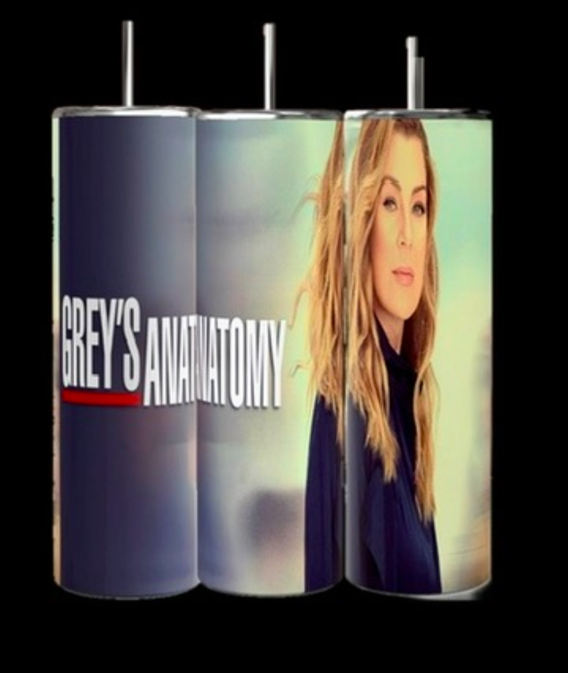 Three stainless steel tumblers are shown. Two feature the text "Grey's Anatomy" in a bold font with a red line underneath. The third tumbler, from Kreative Kreationz, is named "Meredith Grey | Grey’s Anatomy 20oz Tumbler" and comes with a reusable straw. It displays an image of Meredith Grey with wavy blonde hair and a serious expression, wearing a dark outfit.