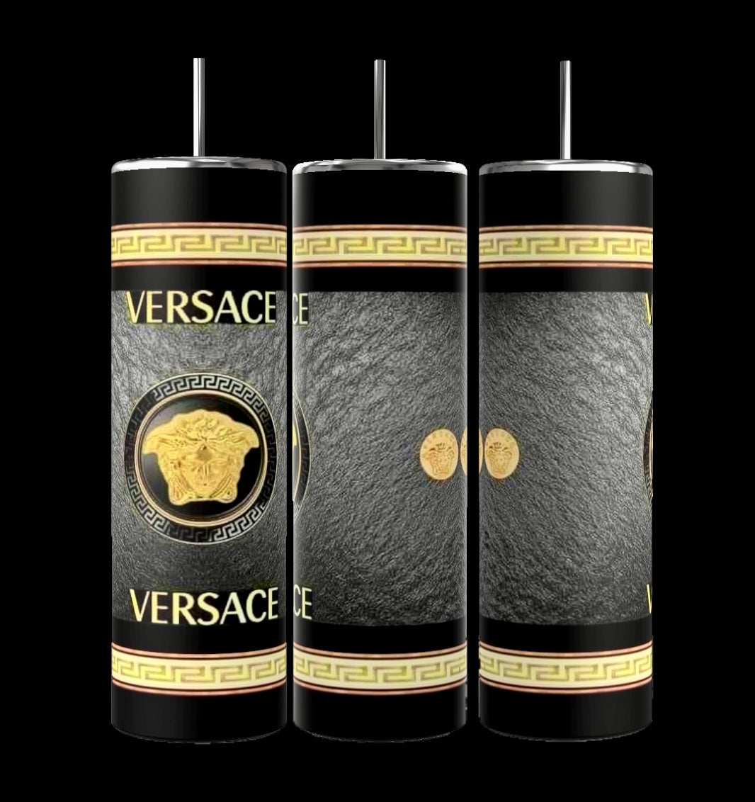 Three dark blue cylindrical tumblers, inspired by the luxury GUCCI Diana design and crafted by Kreative Kreationz, each featuring a textured pattern. These elegant tumblers boast prominent gold and red buckle designs, include a reusable straw, and flaunt a sleek, minimalistic aesthetic against a dark blue background. Each tumbler has an impressive 20 oz capacity.
