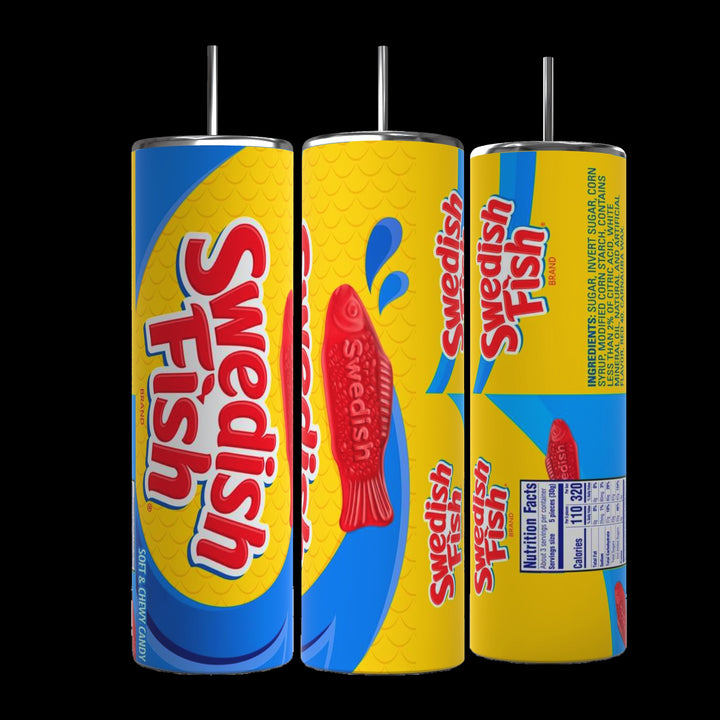 Three cylindrical Swedish Fish 20oz Stainless Steel Skinny Tumblers by Kreative Kreationz are displayed, each featuring a vibrant candy design. Predominantly blue and yellow with red fish graphics and the text "Swedish Fish," one tumbler comes with nutritional facts on the back. All have metal straws, making them perfect stainless steel tumblers for any occasion.