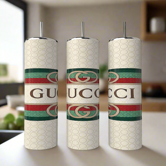 A set of three 20oz Gucci tumblers by Kreative Kreationz, each crafted from eco-friendly reusable materials, showcase a patterned design with bold logos and horizontal green and red stripes featuring the interlocking 