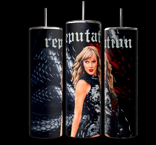 Three cylindrical tumblers with metal straws stand against a black background. The first Taylor Swift Reputation Snake 20oz Tumbler by Kreative Kreationz features a close-up of a black snake's scales pattern. The central tumbler shows a woman with blonde hair in a black outfit. The last tumbler displays a similar snake scale pattern with the text "Reputation" across the top of all three tumblers, highlighting their durable construction.
