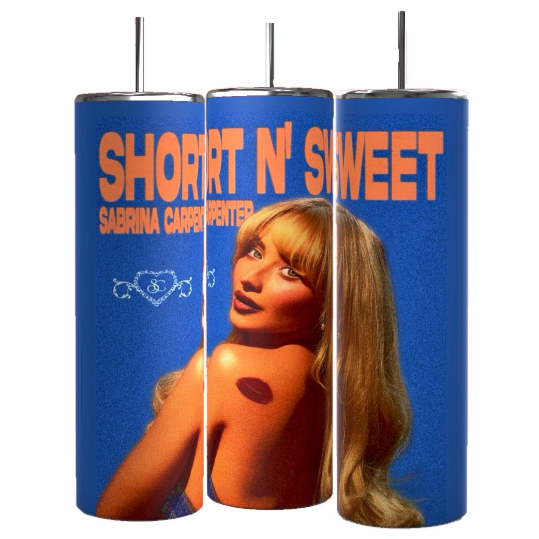 Three retro-style cylindrical tumblers with straws, branded as "Short & Sweet Sabrina Carpenter 20 oz Tumbler" by Kreative Kreationz, showcase a blonde woman and the text “Short N’ Sweet” and “Sabrina Carpenter” in bold orange letters against a blue background. Each durable tumbler has a 20 oz capacity and keeps beverages hot or cold.