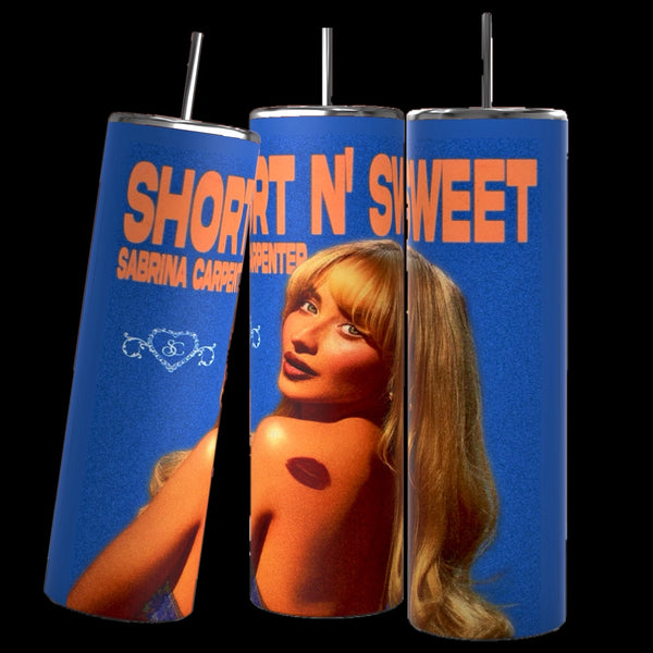 Three retro-style cylindrical tumblers with straws, branded as "Short & Sweet Sabrina Carpenter 20 oz Tumbler" by Kreative Kreationz, showcase a blonde woman and the text “Short N’ Sweet” and “Sabrina Carpenter” in bold orange letters against a blue background. Each durable tumbler has a 20 oz capacity and keeps beverages hot or cold.