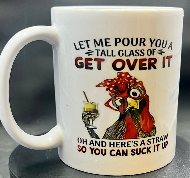 The Chicken Ceramic Mug by Kreative Kreationz features an adorable illustration of a chicken wearing a red bandana and glasses, holding a yellow drink and straw. The text humorously reads, "Let me pour you a tall glass of get over it. Oh and here's a straw so you can suck it up." It's the perfect gift for Swiftie fans!