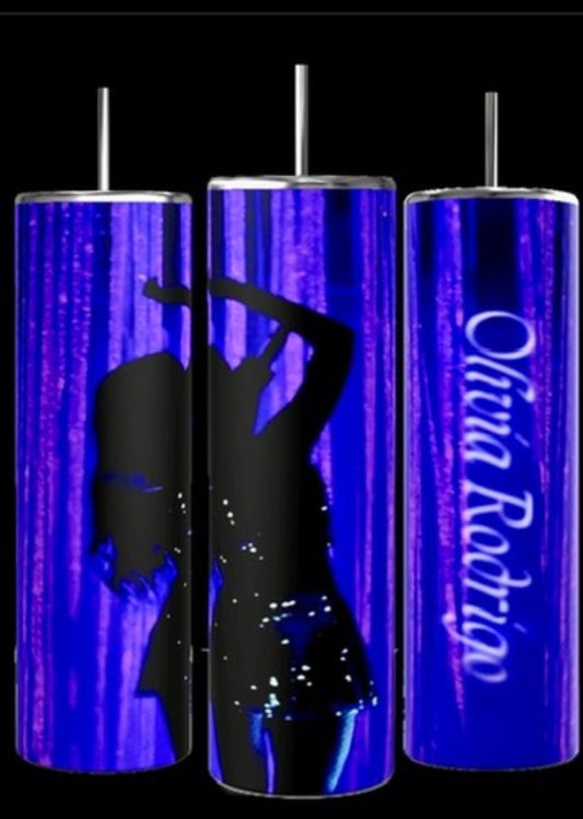 Image showing three tall, cylindrical Olivia Rodrigo 20oz Tumblers by Kreative Kreationz, each equipped with a metal straw. The tumblers feature a blue background with a silhouette of a dancing figure on two of them and the name "Olivia Rodrigo" in script on the third. These tumblers boast durable construction to keep beverages hot or cold.