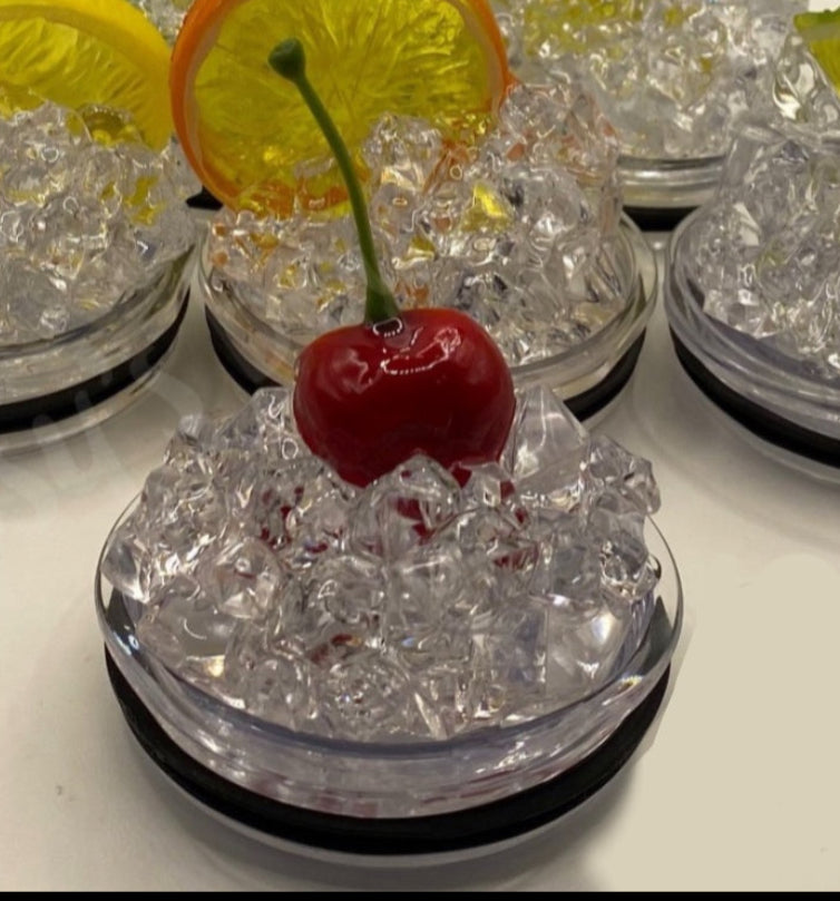 A slice of lime sits atop a pile of crushed ice, elegantly displayed on a small, round, clear platform against a beige background that accentuates the lime and ice. A black strip at the bottom features white text reading "3D Lid Topper for standard 20oz Tumbler." This setup by Kreative Kreationz is an ideal accessory for any tumbler.