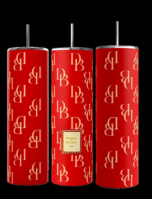 The D&B | RED 20oz Tumblers from Kreative Kreationz are tall and feature a repeating cream-colored "DB" monogram pattern. The center tumbler displays a square with gold text that reads "Dooney & Bourke 1975." Each tumbler, crafted with double-wall insulation, comes with a black and silver straw.