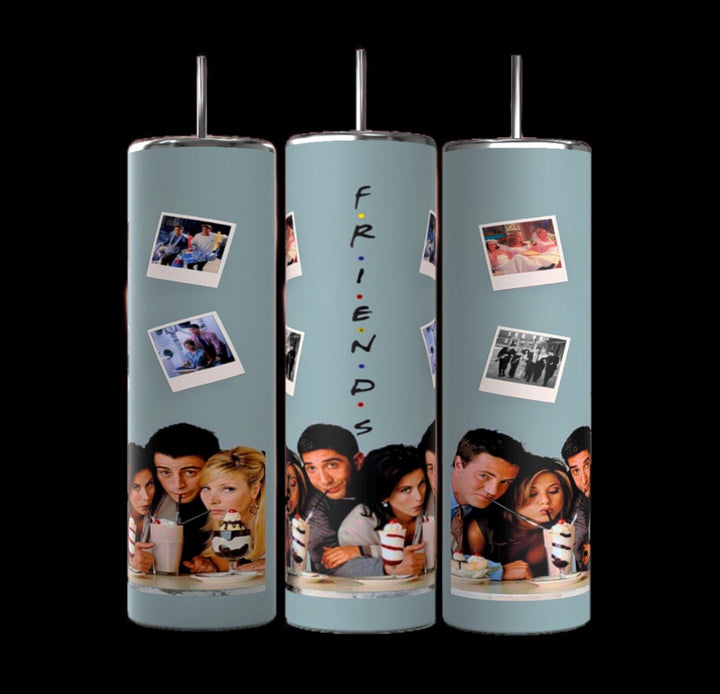 Three cylindrical Teal Friends TV Show 20oz Tumblers by Kreative Kreationz feature images from the TV show "Friends." Each tumbler showcases a cast photo and Polaroids of memorable moments. The central tumbler displays the word "FRIENDS" vertically. With double-wall insulation and a muted green background, they come in a stylish gift box.