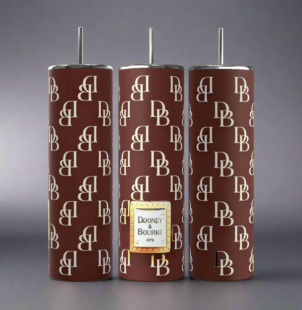 Three tall, cylindrical D&B 20oz tumblers in burgundy from Kreative Kreationz feature a repeating "DB" pattern in cream. One tumbler showcases a gold "Dooney & Bourke 1975" label. Each boasts double-wall insulation for enhanced temperature control.