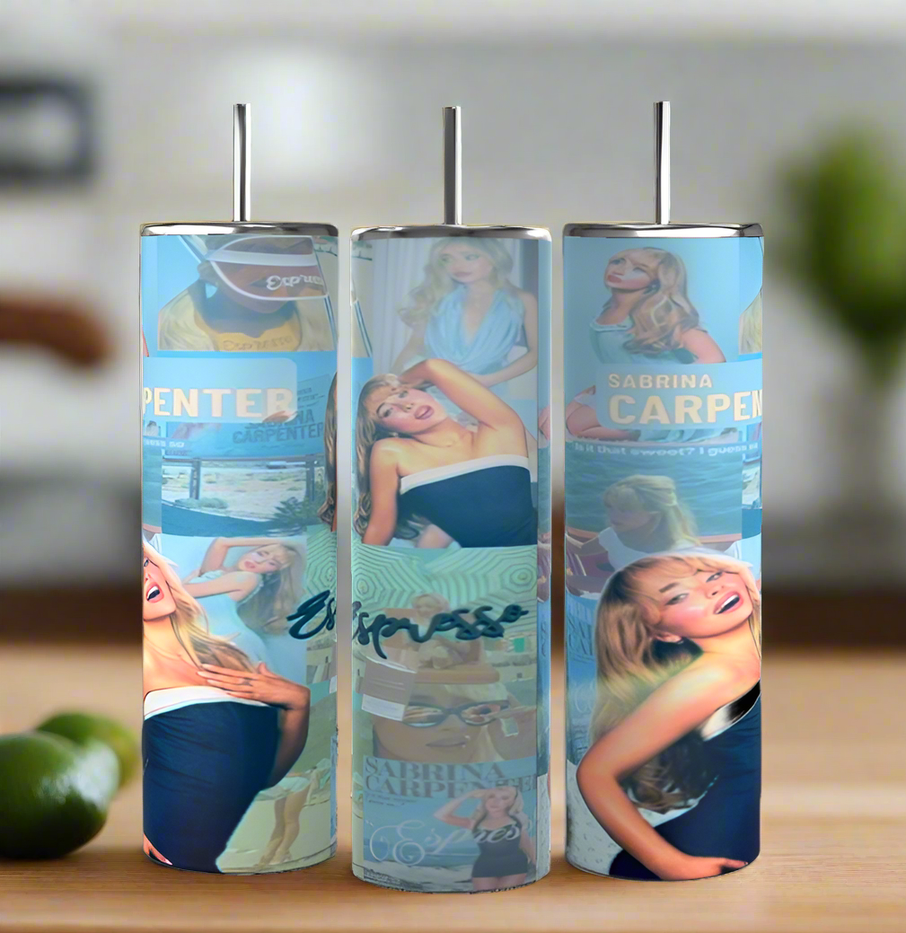 On a wooden surface are three tall, luxurious Sabrina Carpenter Expresso Tumblers by Kreative Kreationz, each with straws. Decorated with stylish images of a smiling Sabrina Carpenter and featuring "Express," they offer an eco-friendly, chic look with softly blurred lime fruit in the background.