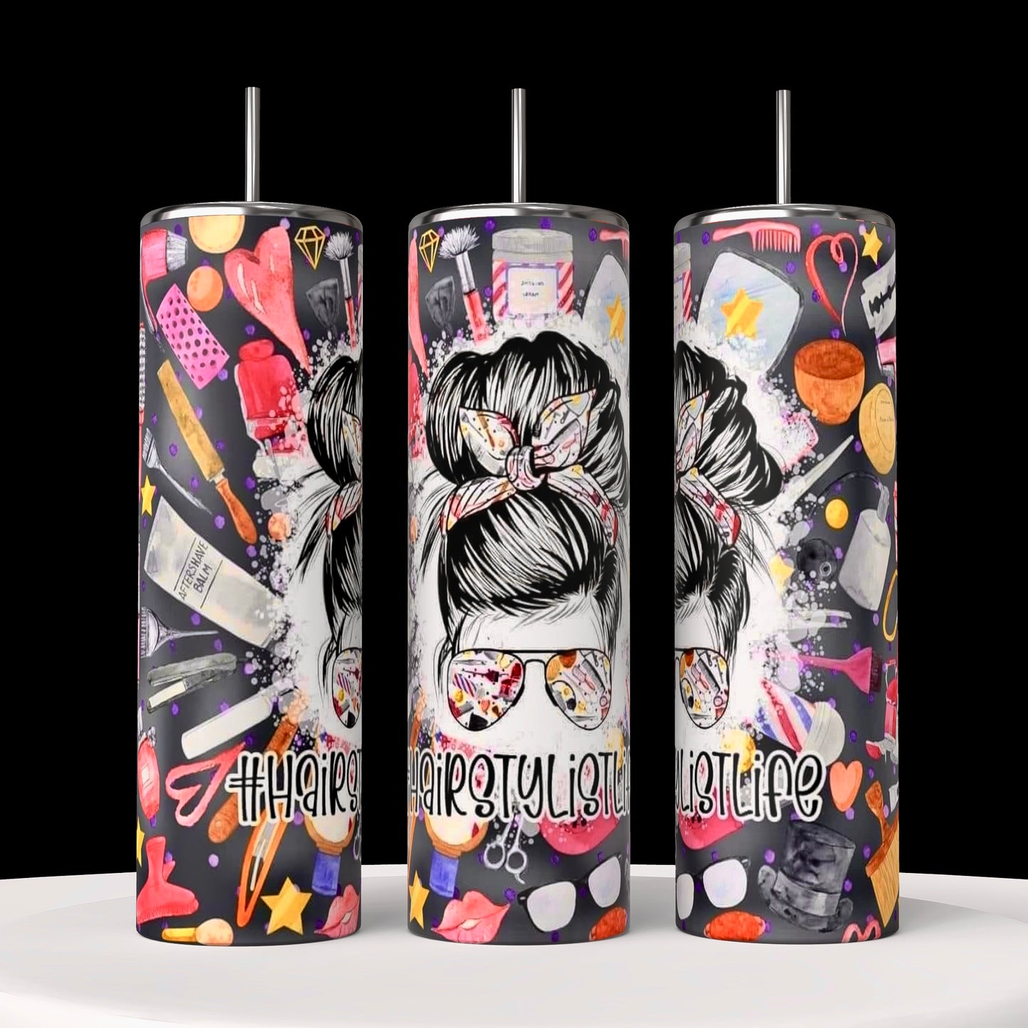 Three cylindrical tumblers from the Hairstylist Collection by Kreative Kreationz are displayed against a black background. Each 20oz tumbler showcases a pattern of various hairstyling tools, including scissors, clippers, combs, hairdryers, mirrors, and pink roses on a black background. Experience durable construction with every use.