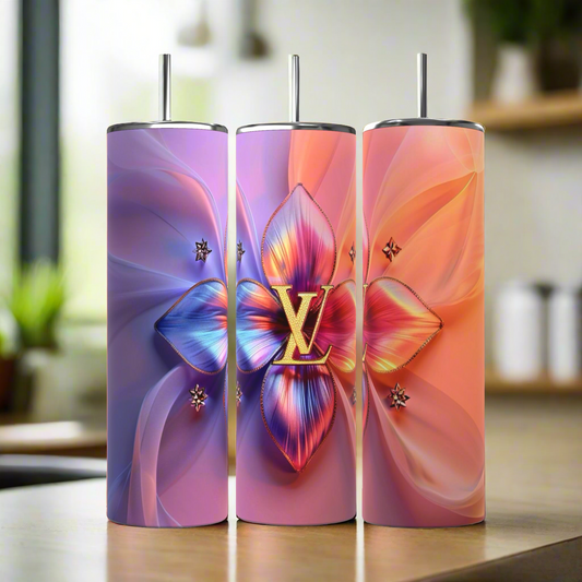 Three tall, cylindrical LV Puffy 20oz Tumblers by Kreative Kreationz come complete with metal straws. The first tumbler showcases a gradient background transitioning from blue to violet, adorned with a large, colorful floral centerpiece. The middle and right tumblers feature similar floral designs, each boasting unique color gradients and durable construction for maximum longevity.