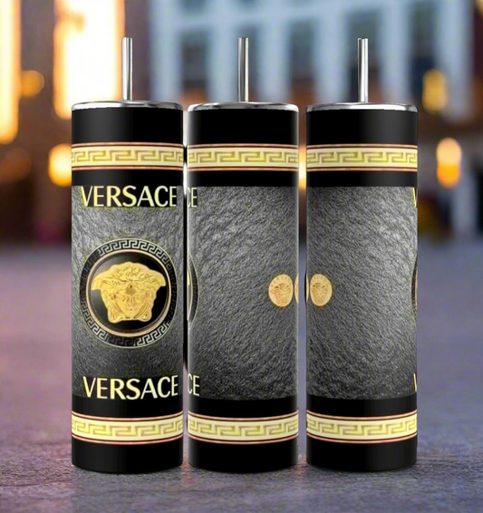 Three dark blue cylindrical tumblers, inspired by the luxury GUCCI Diana design and crafted by Kreative Kreationz, each featuring a textured pattern. These elegant tumblers boast prominent gold and red buckle designs, include a reusable straw, and flaunt a sleek, minimalistic aesthetic against a dark blue background. Each tumbler has an impressive 20 oz capacity.
