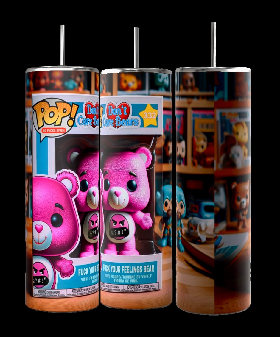 Three cylindrical 20 oz skinny tumblers from Kreative Kreationz, each featuring vibrant designs. Two of the tumblers showcase a pink bear character with a furious expression, branded with "Don't Care Bears" and "Fuck Your Feelings Bear" as part of the Don’t Care Bear Collection. The third tumbler displays shelves adorned with similar character figurines.