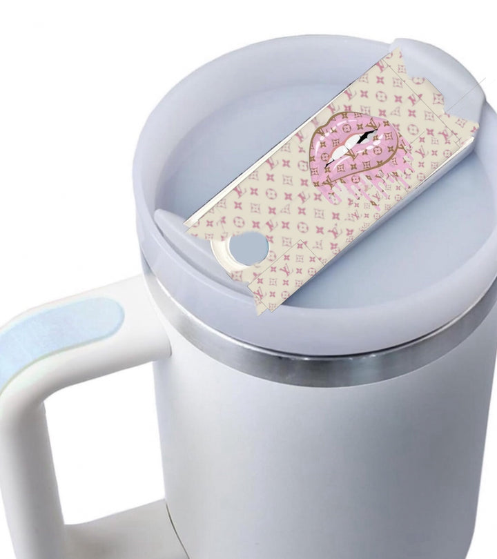 Stanley tumbler featuring a Pink and Beige Louis Vuitton Dripping Lips lid topper, a stylish designer accessory