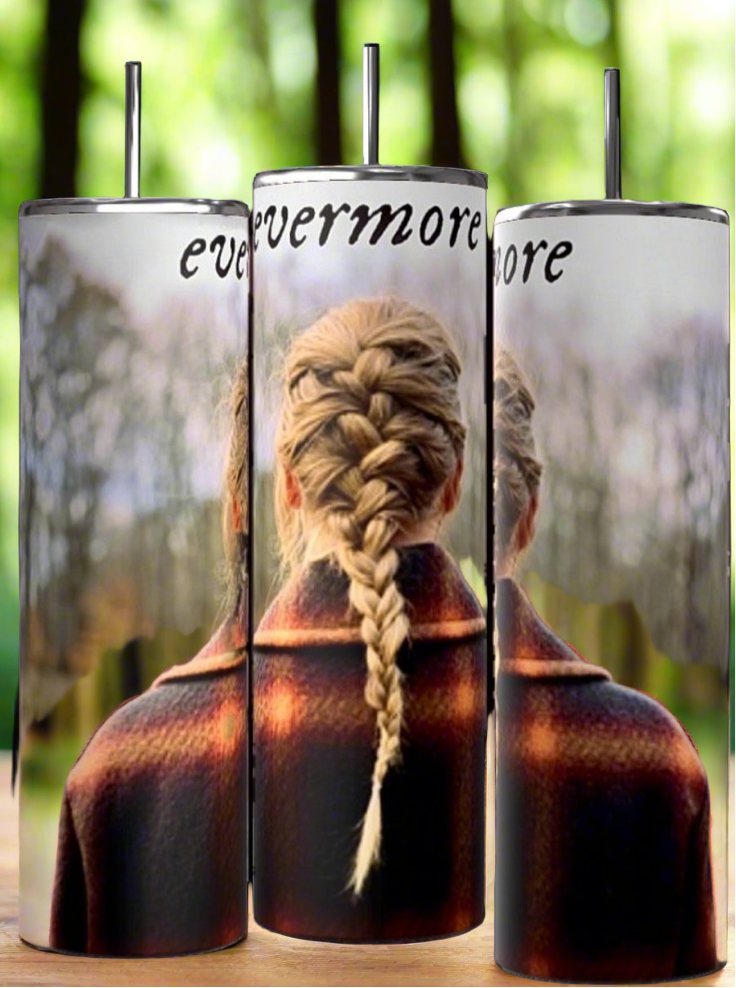 Three Evermore | Taylor Swift 20oz Skinny Tumblers by Kreative Kreationz with spill-proof lids are displayed on a wooden surface with a forest background. Each tumbler features an image of a person with a braided hairstyle facing away and the word "evermore" written at the top.