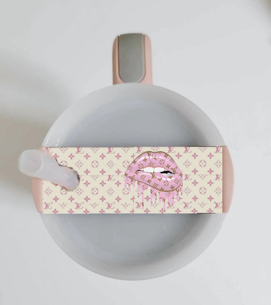 Pink and beige Louis Vuitton Dripping Lips Stanley tumbler lid topper, a luxurious designer accessory