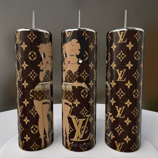 The Betty B LV 20oz Skinny Tumblers by Kreative Kreationz feature a brown designer pattern with monogram logos and playful Betty Boop illustrations. These sublimated tumblers capture her charm and whimsy, making them ideal for collectors and fans.