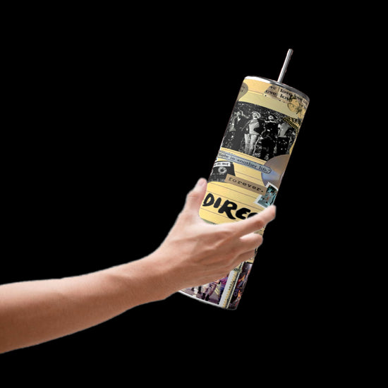 A hand holds the One Direction Aesthetic Collage 20oz Stainless Steel Tumbler by Kreative Kreationz, featuring a vibrant collage of black and yellow comic-style illustrations and text, designed for durability. The background is a striking black.