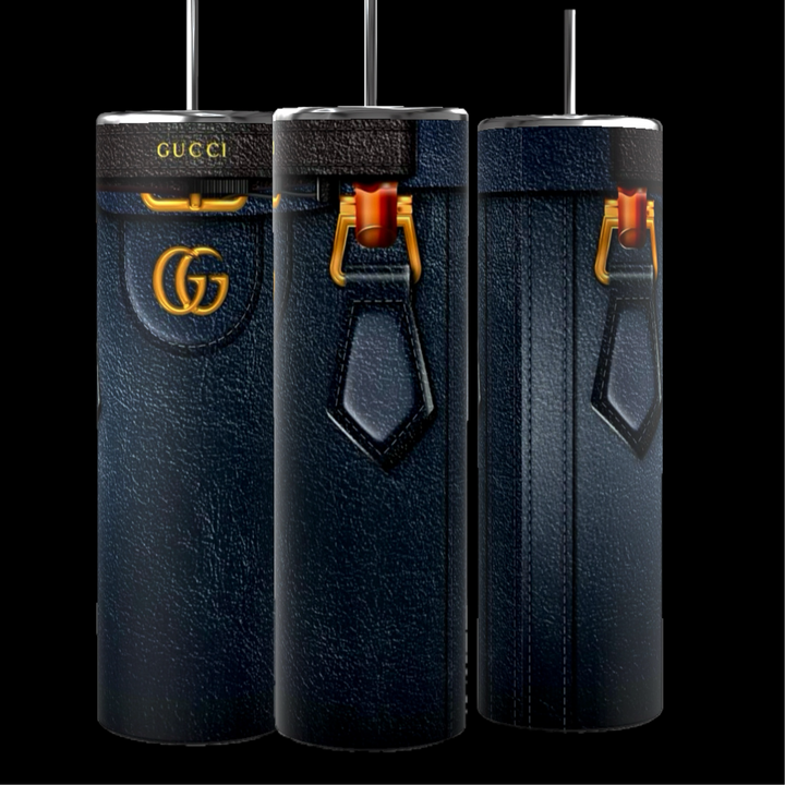 Three tall, cylindrical objects crafted to resemble luxury handbags and featuring a dark leather-like texture. These Kreative Kreationz Gucci Diana Purse 20oz tumblers are embellished with gold accents and signature patterns, and come with a spill-proof lid for added convenience.