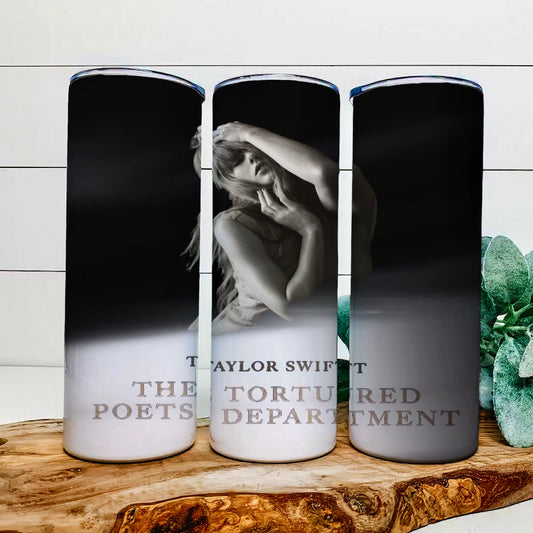 Three tall candles with black and white images sit on a wooden surface. The center one, styled like a Kreative Kreationz TTPD | Tumbler, features someone posing with hands near their face. The text reads "Taylor Swift The Tortured Poets Department.