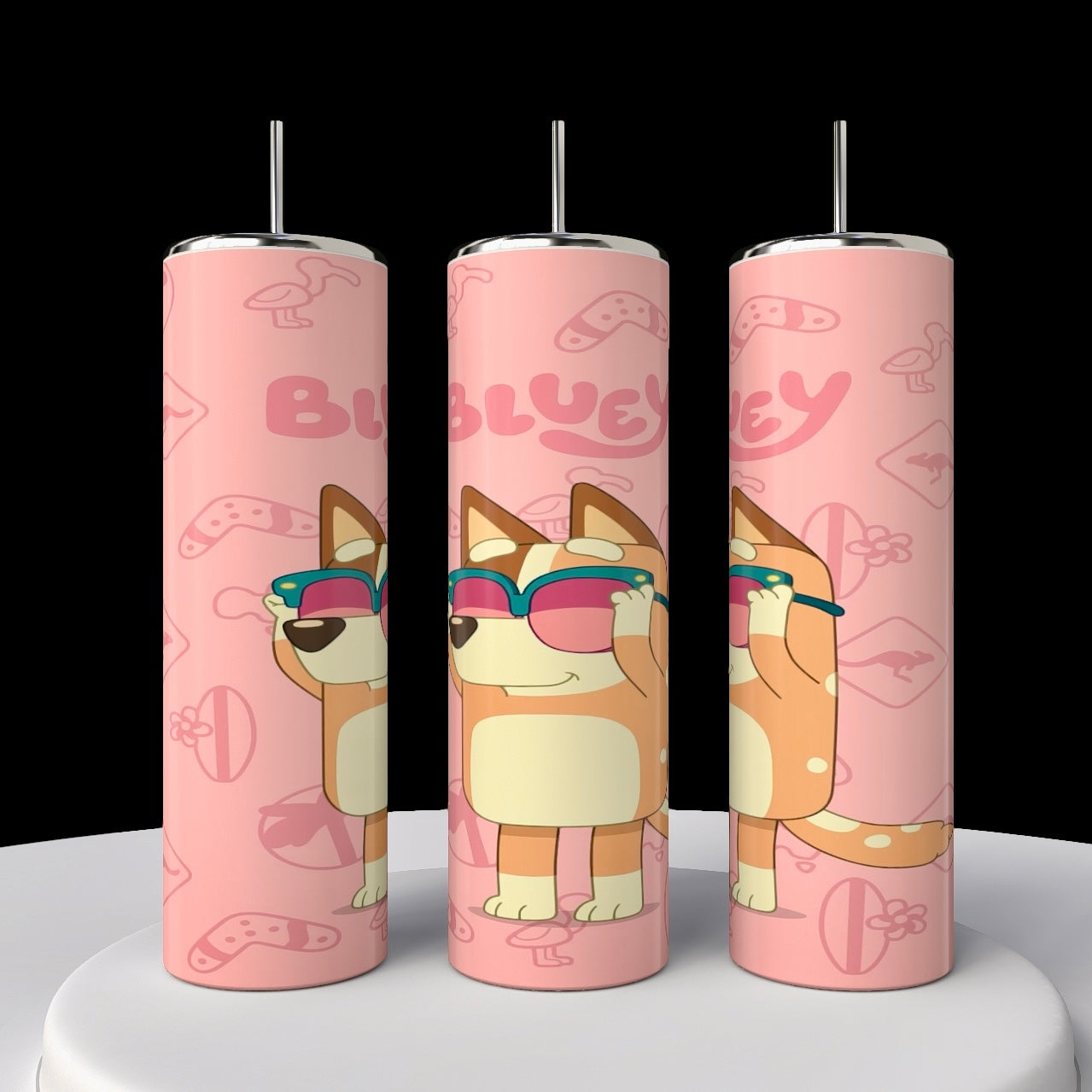 This set of three pink, stainless steel Bluey 20oz tumblers from Kreative Kreationz features a cartoon dog with sunglasses and playful icons like bones and paw prints. Each sublimated tumbler prominently displays the word "BLUEY.