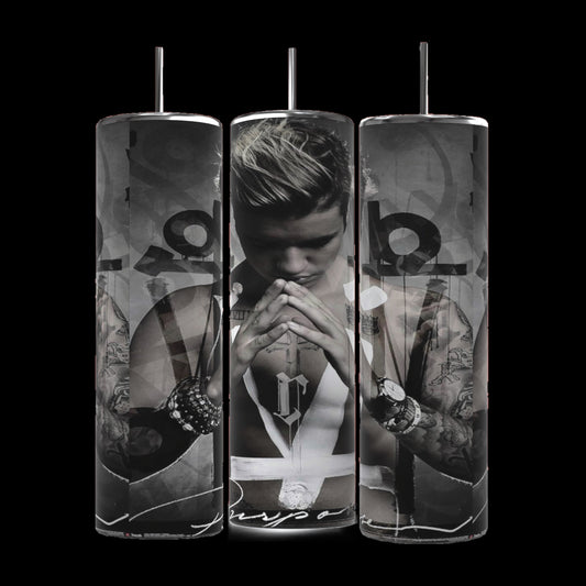 Three cylindrical Justin Bieber Prayer 20oz Tumblers by Kreative Kreationz feature monochrome images of a contemplative Justin Bieber, adorned with tattoos and wearing a sleeveless shirt and several bracelets. His hands are pressed together in a prayer-like gesture, with the word "Purpose" visible at the bottom. These tumblers keep beverages hot or cold.