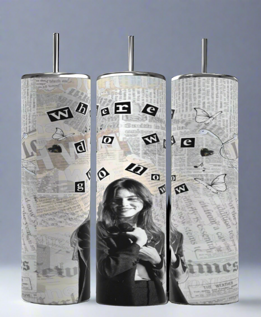 Three tall tumblers are shown against a gray backdrop. Each 20 oz capacity Gracie Abrams NY Times Music Skinny Tumbler by Kreative Kreationz is decorated with black-and-white images of a smiling woman, newspaper clippings, and scattered butterfly illustrations. The words "where do we go now" are arranged across the sublimated tumblers.