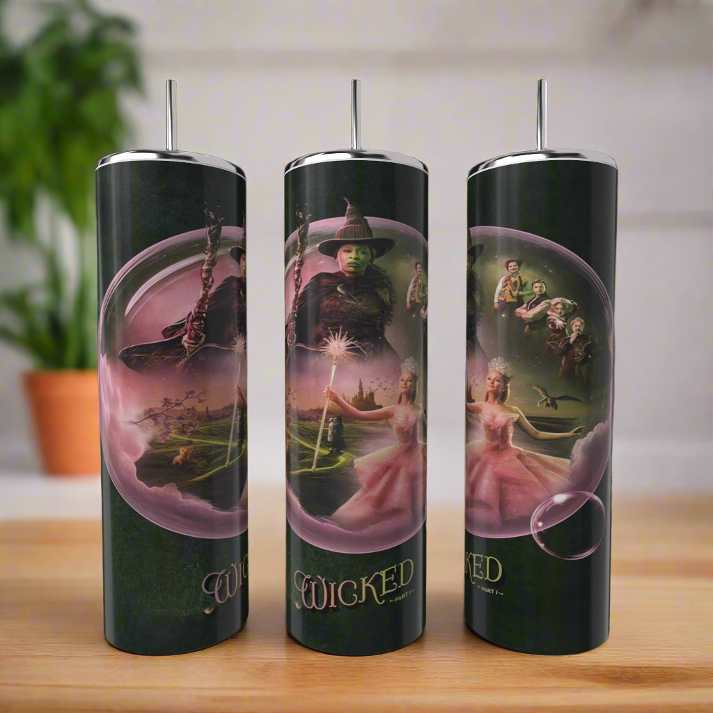 Three Wicked Bubble 20oz Tumblers by Kreative Kreationz feature a "Wicked" theme with witches and landscapes. Each stainless steel tumbler is tall, insulated, and includes a straw. A plant is blurred in the background.