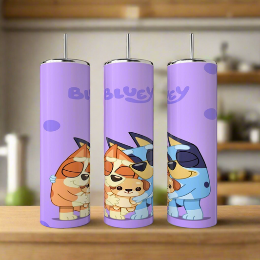 Three purple 20 oz Kreative Kreationz Bluey stainless steel tumblers, featuring sublimated designs of cartoon dogs hugging and "Bluey" at the top, are displayed on a wooden surface.