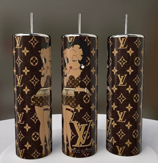 The three cylindrical Betty B LV 20oz Skinny Tumblers from Kreative Kreationz feature a cartoon character design on a brown background with "LV" logos and floral motifs. Each sublimated tumbler includes a silver lid and straw, elegantly displayed on a circular platform.