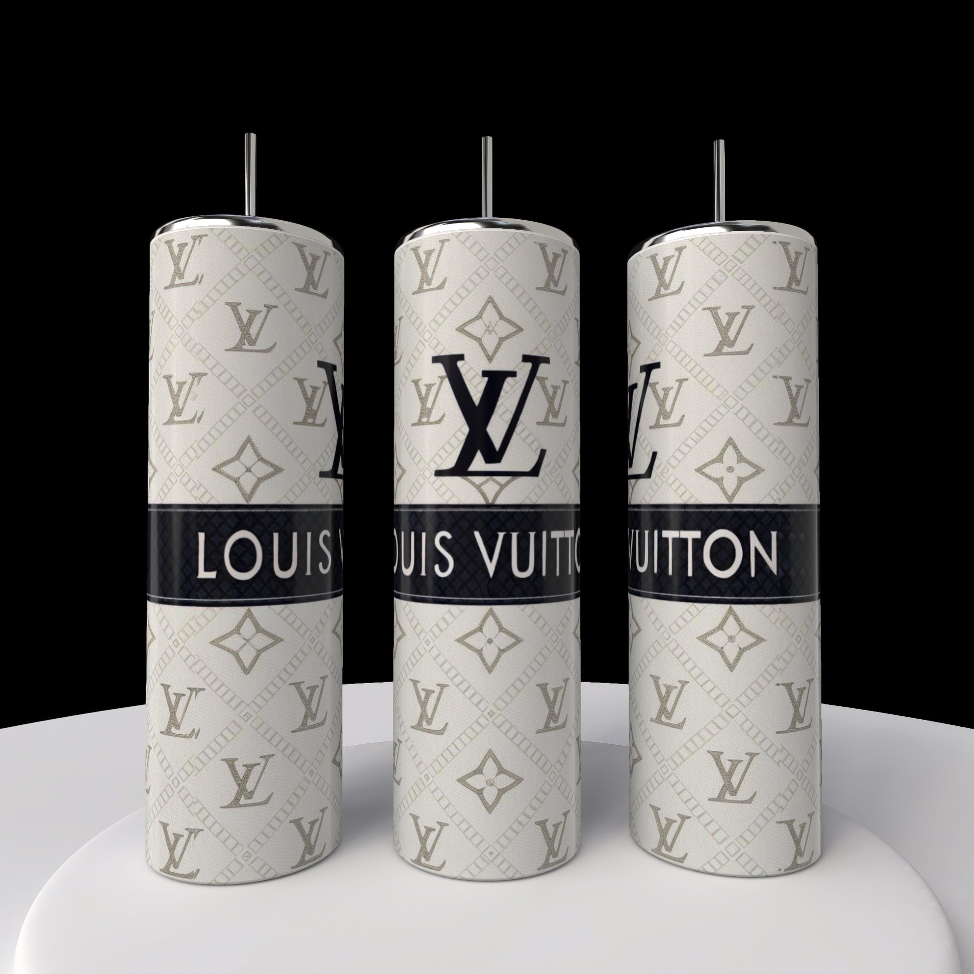 Three silver Kreative Kreationz LV 20oz Skinny Tumblers with straws are lined up on a white surface, showcasing black Louis Vuitton logos and branding on a patterned silver background. Their sleek, cylindrical design enhances the elegance against the black backdrop.