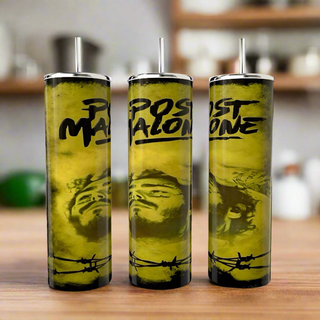 Three Post Malone 20oz tumblers by Kreative Kreationz, with lids and straws, sit on a wooden surface. Each stainless steel, eco-friendly tumbler showcases a yellow and black barbed wire design featuring text "Post Malone" and a partially visible face against a blurred backdrop.