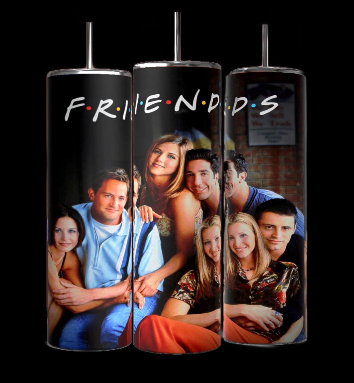 Three tall, stainless steel Friends Tv Show 20oz Tumblers-Group from Kreative Kreationz are displayed side by side. Each tumbler, featuring double-wall insulation, showcases images of the cast from the iconic 90s sitcom against a blurred background. The center tumbler has "F.R.I.E.N.D.S" written across the top in colorful letters.