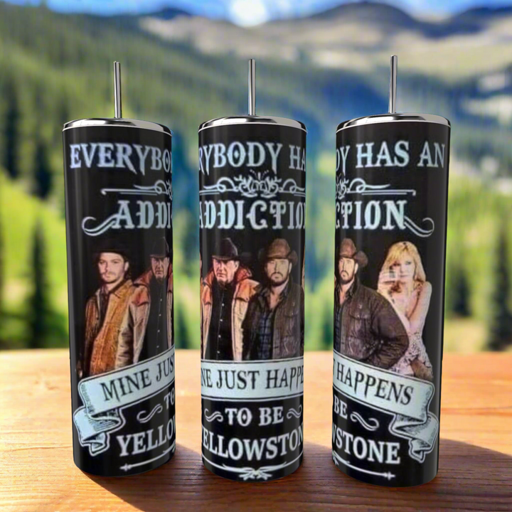 The Yellowstone Addiction 20oz Tumblers by Kreative Kreationz, featuring Western-attired figures with text "Everybody has an addiction, mine just happens to be Yellowstone," and a blurred mountain landscape, are tall, cylindrical with straws, stainless steel finish.