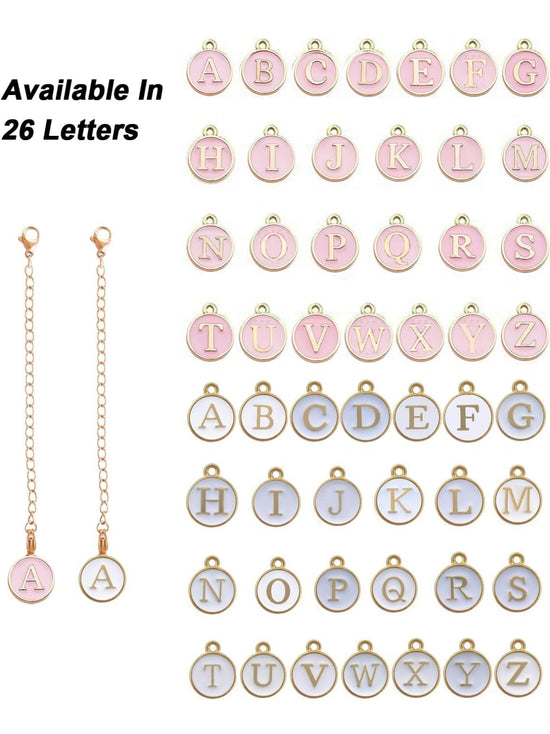 The image showcases a set of round letter charms in pink and blue, each charm displaying a single letter from A to Z. There are two keychain-like chains attached with a pink 'A' charm and a blue 'A' charm at the ends. The text reads “Available In 26 Letters.” The durable name plate design of Kreative Kreationz's Charm Dangle | Tumbler Accessory ensures longevity.