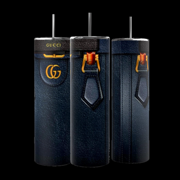 A trio of Gucci Diana Purse 20oz Tumblers from Kreative Kreationz, showcasing elegant leather-like exteriors with luxury branding and gold accents, along with a unique strap design and spill-proof lids, are beautifully displayed against a black background.